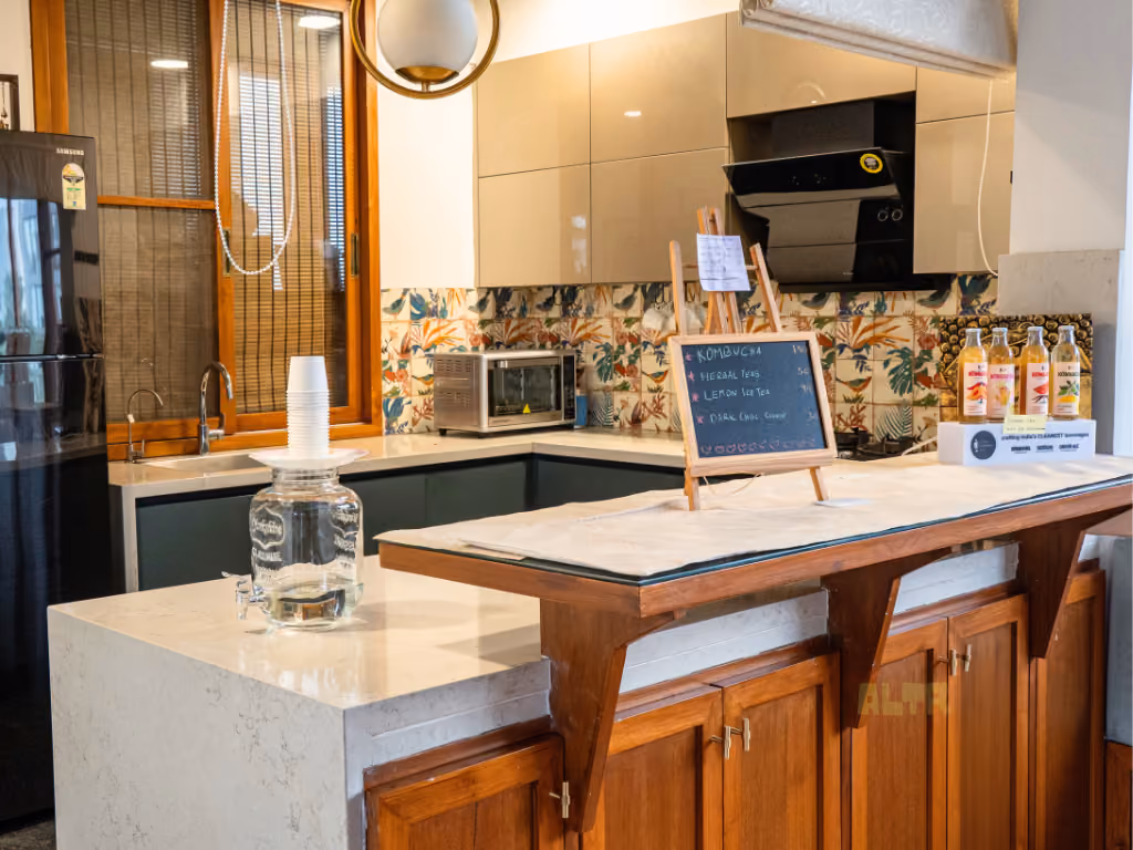 The pantry counter with a chalkboard drinks list and patterned bird tiles behind it