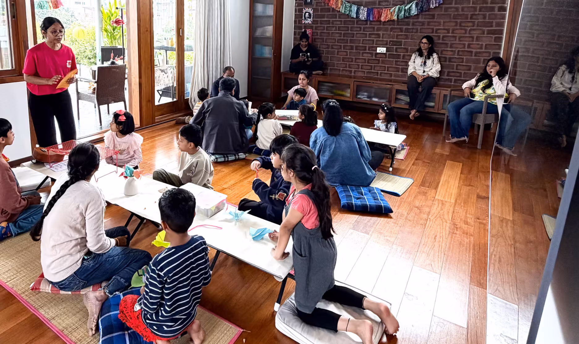 A workshop in full swing at Sanctuary, tables covered in materials